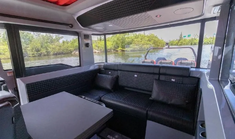  Yacht Photos Pics Interior of 2021 BRABUS Brabus Shadow 900 BO luxury boat with black seating and table.