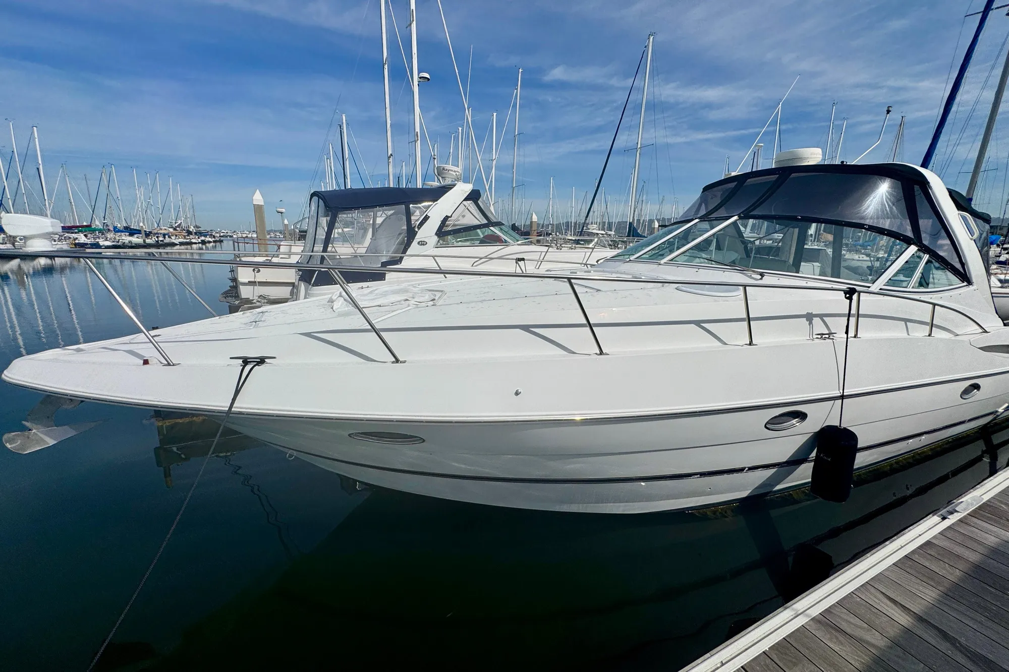 2001 Cruisers Yachts 3470 Express docked in a marina under clear skies.