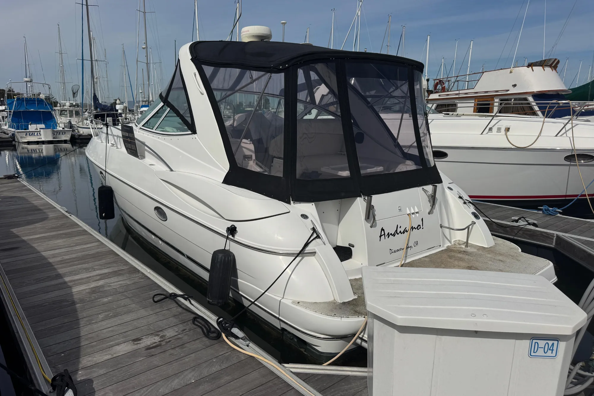 2001 Cruisers Yachts 3470 Express docked at marina, rear view with canopy.