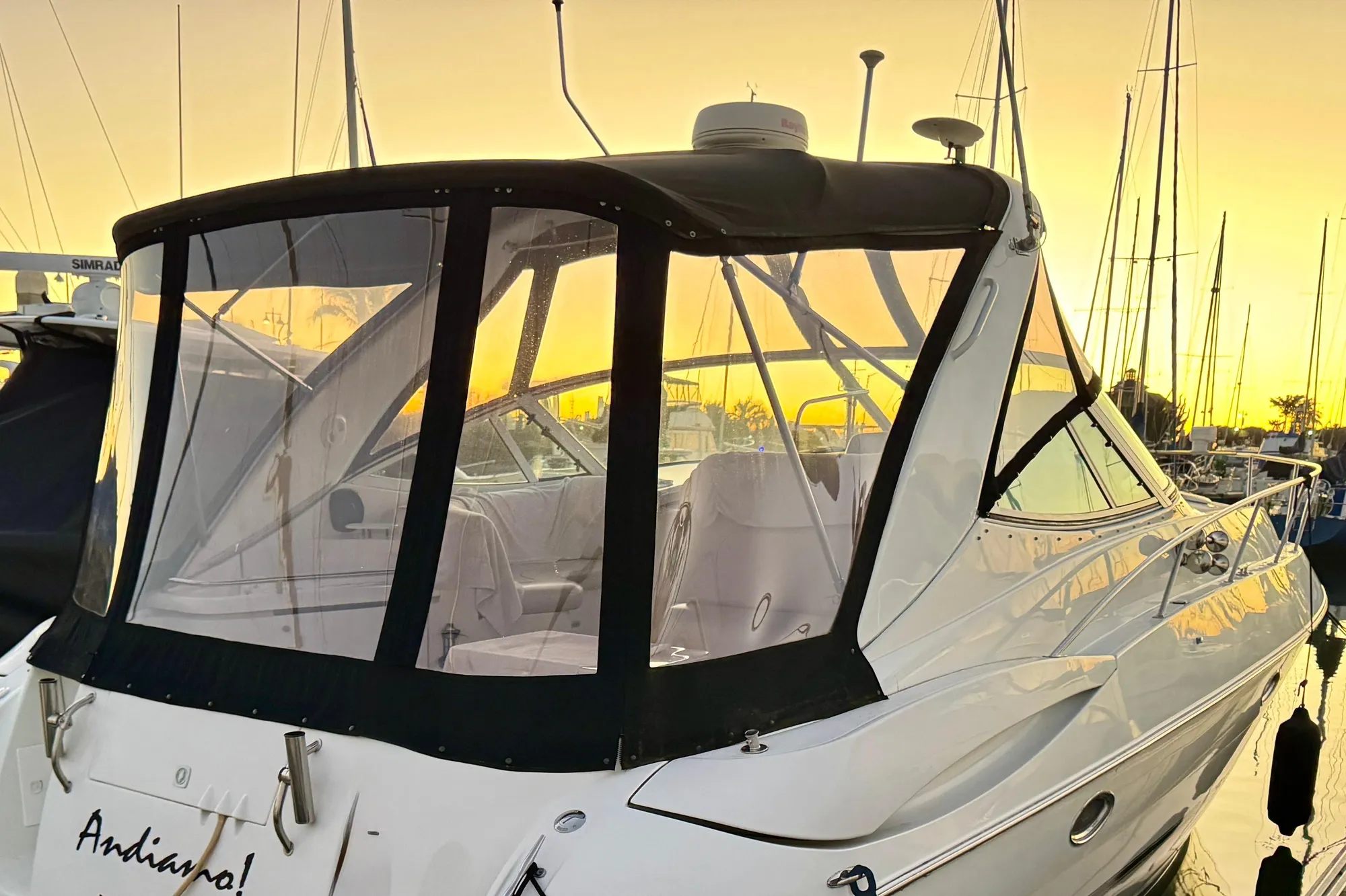 2001 Cruisers Yachts 3470 Express at sunset in marina.