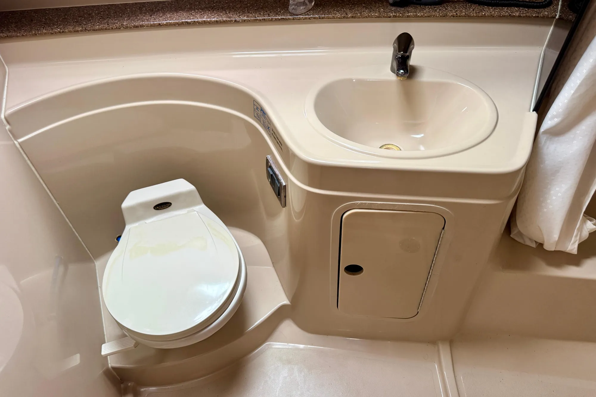 2001 Cruisers Yachts 3470 Express bathroom with toilet and sink.