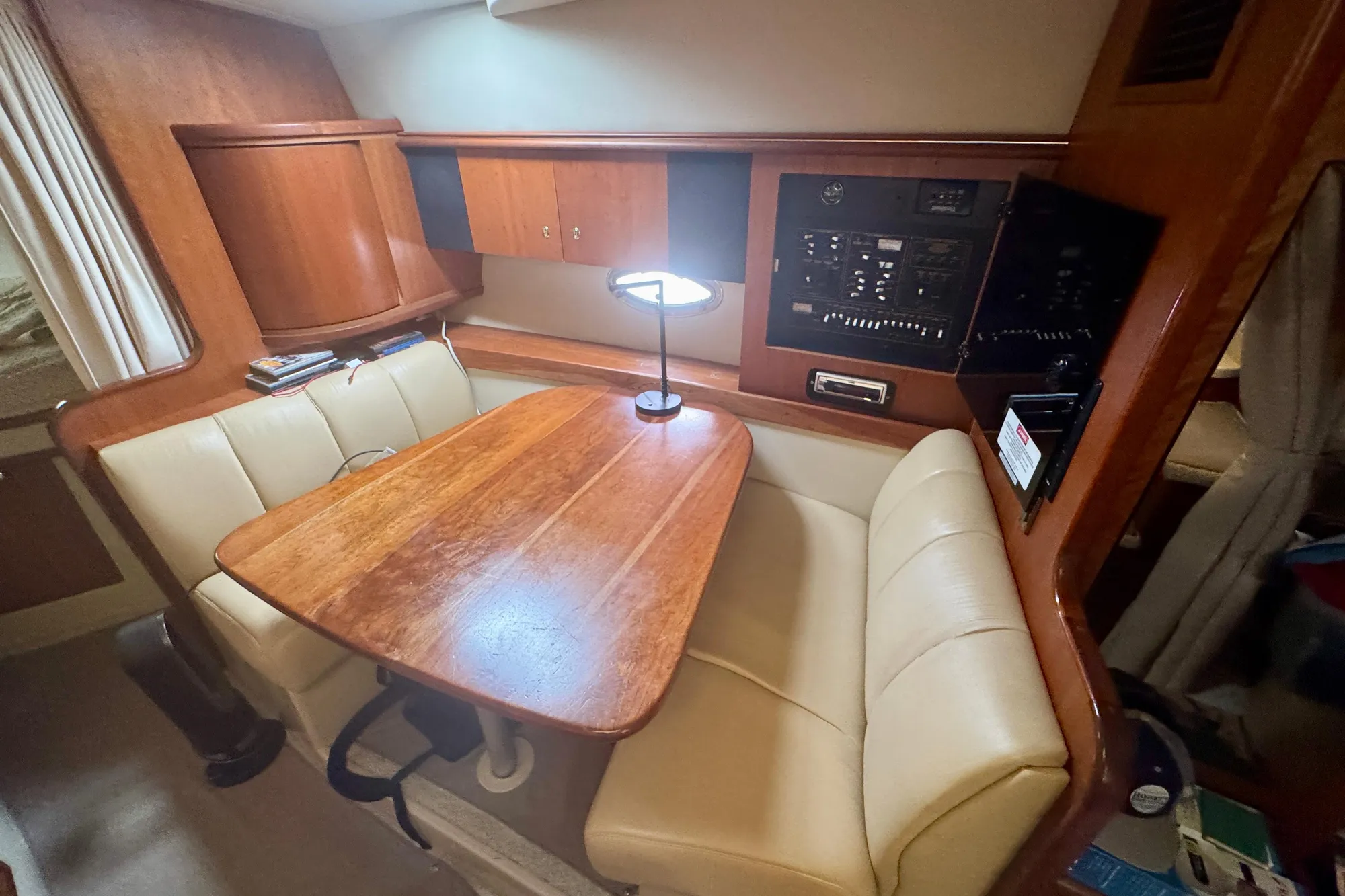 2001 Cruisers Yachts 3470 Express cabin with wooden table and beige seating.
