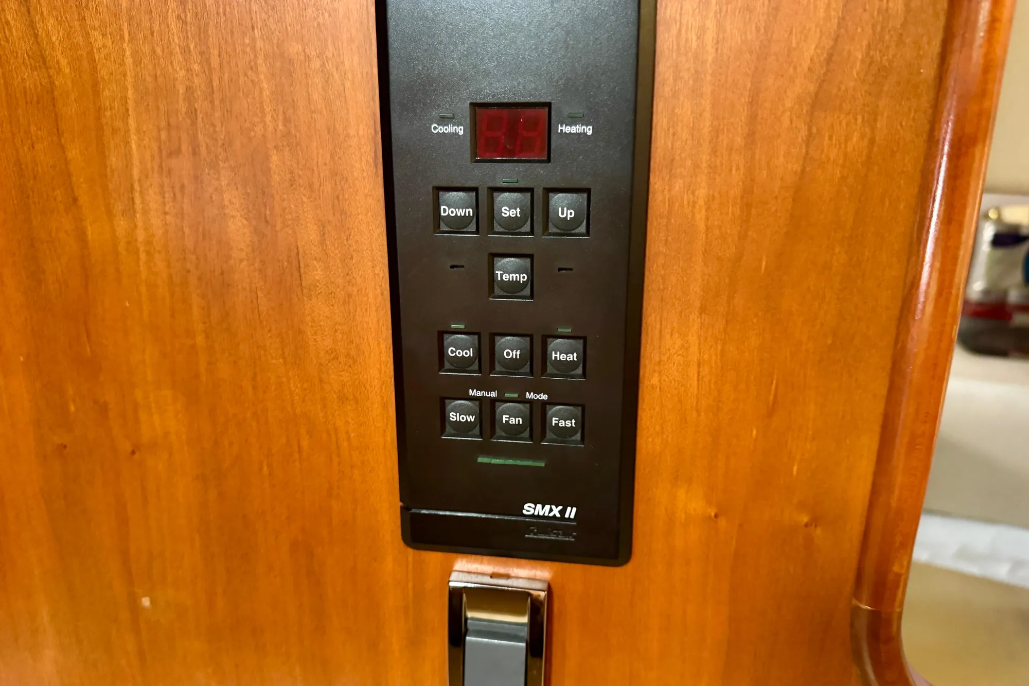 Control panel of a 2001 Cruisers Yachts 3470 Express, featuring temperature and fan settings.