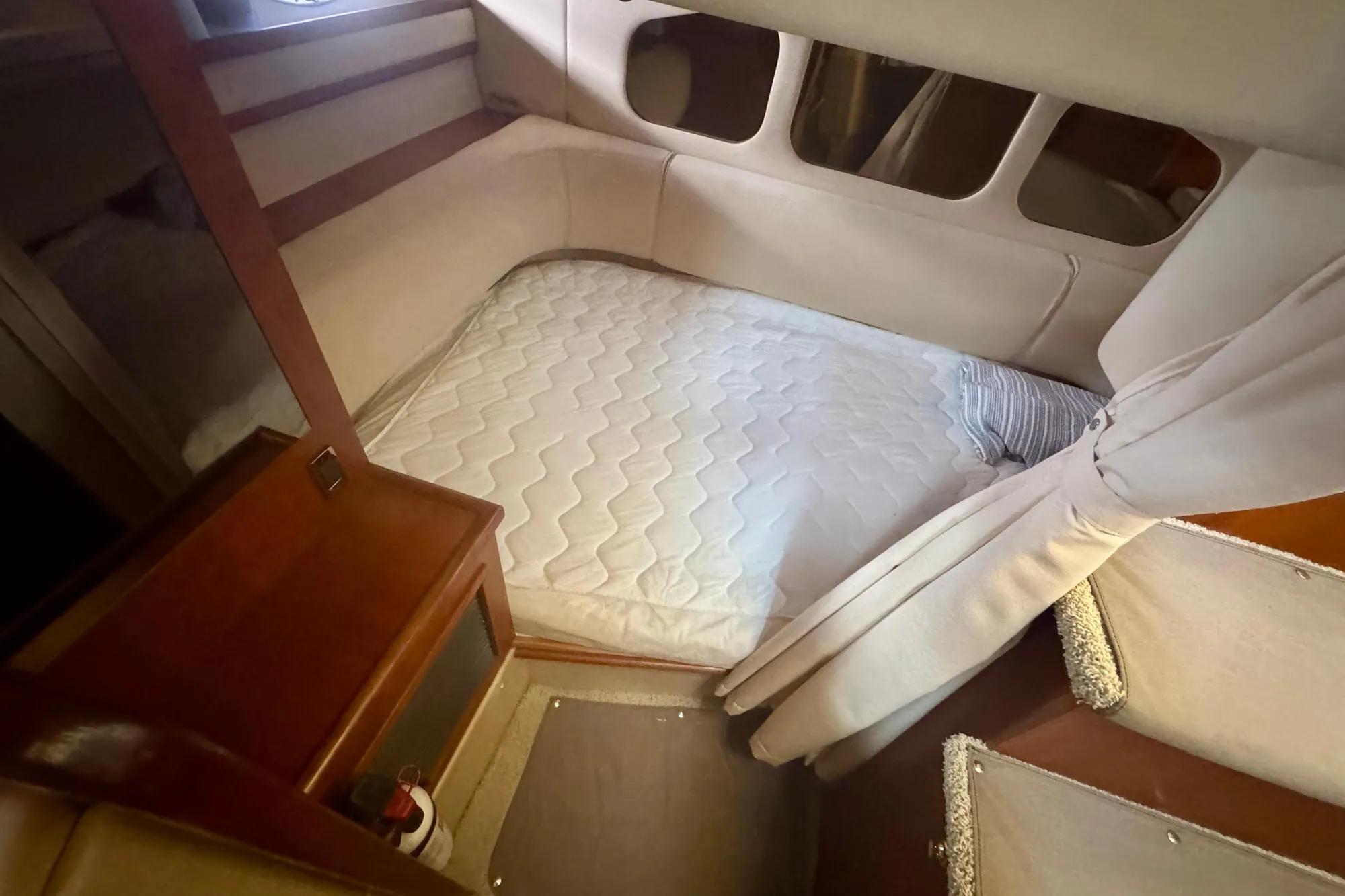 2001 Cruisers Yachts 3470 Express cabin interior with bed and wooden furnishings.
