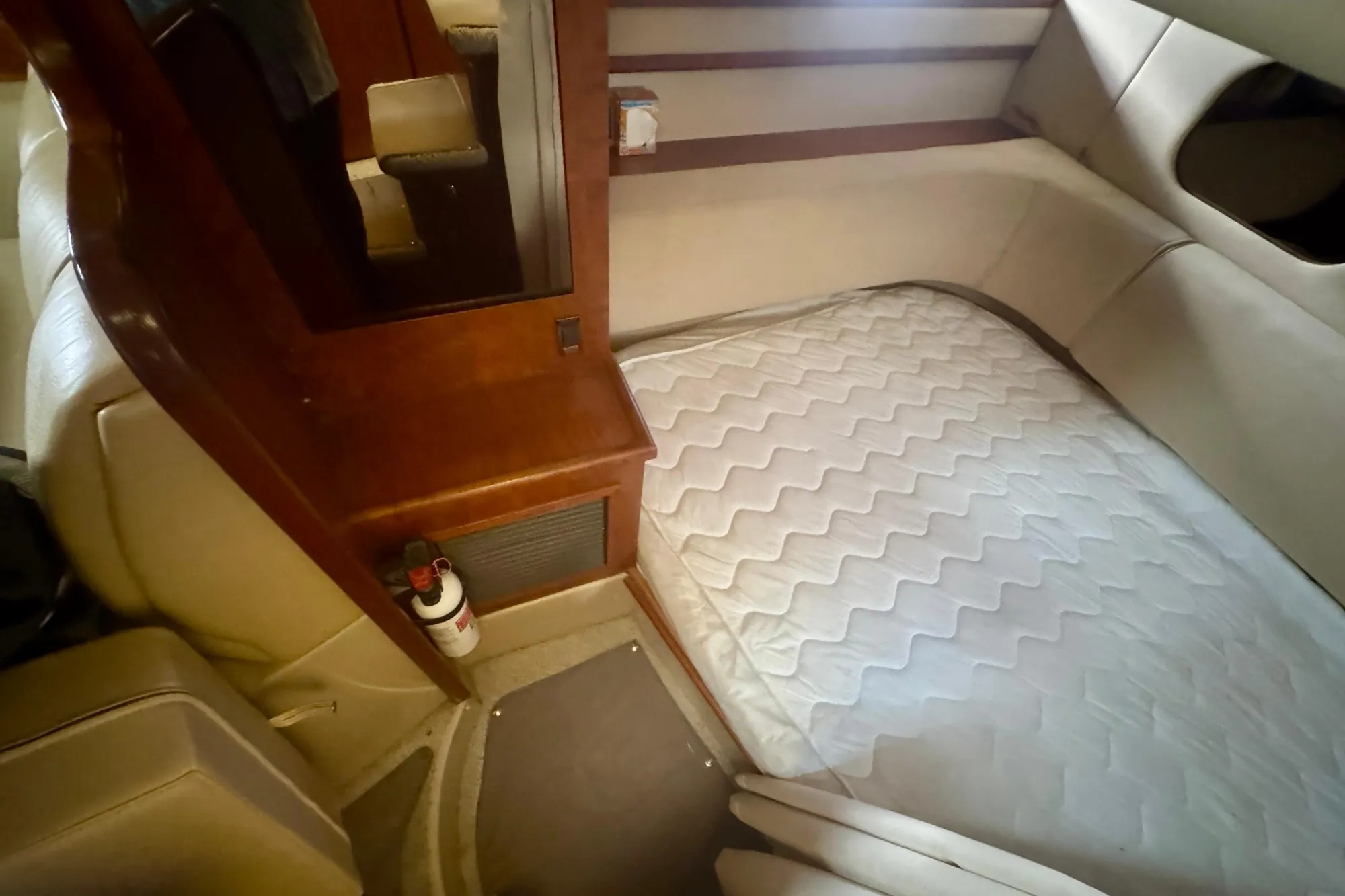2001 Cruisers Yachts 3470 Express cabin interior with bed and wooden accents.
