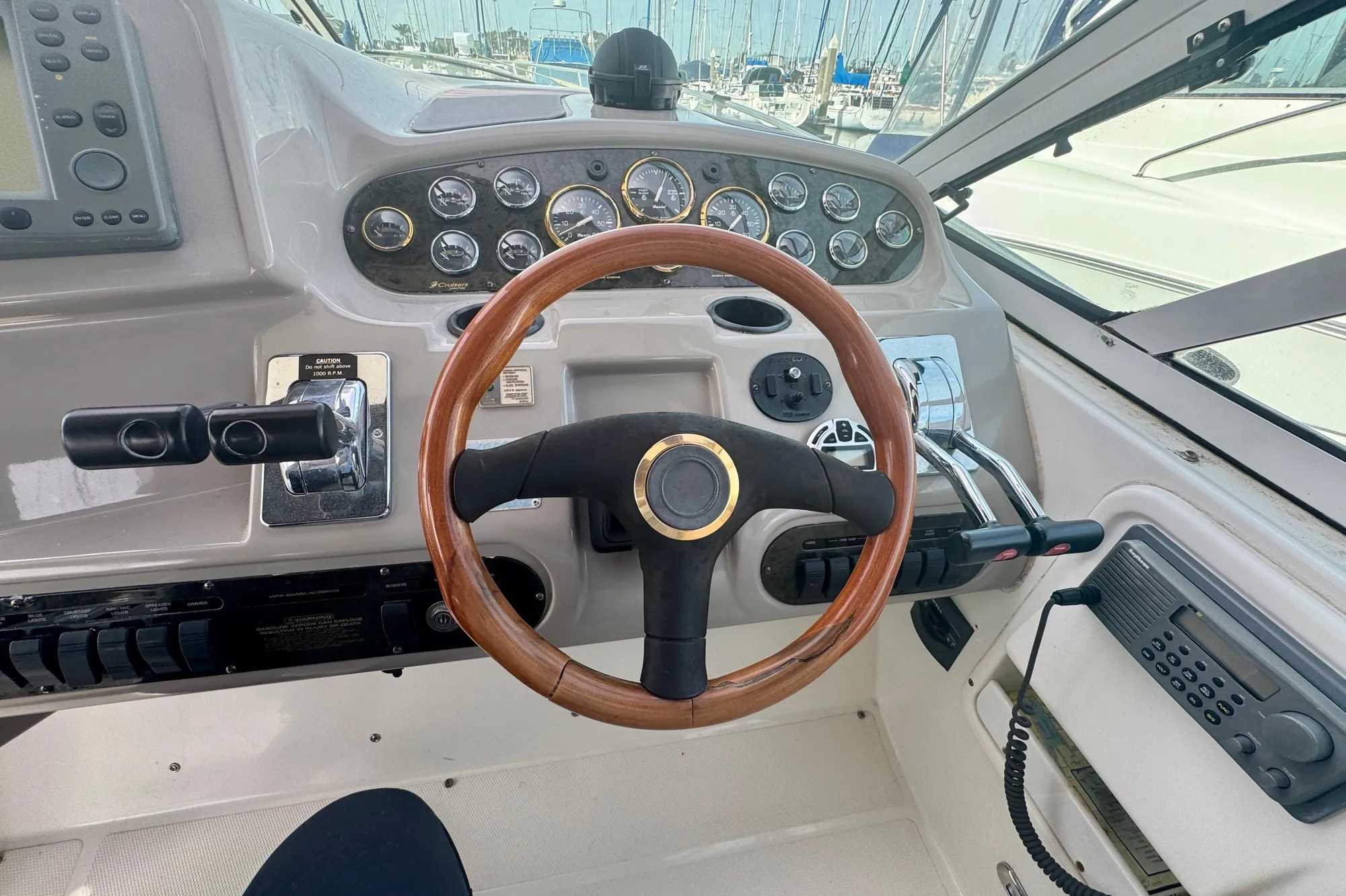 2001 Cruisers Yachts 3470 Express helm with wooden steering wheel and control panel.