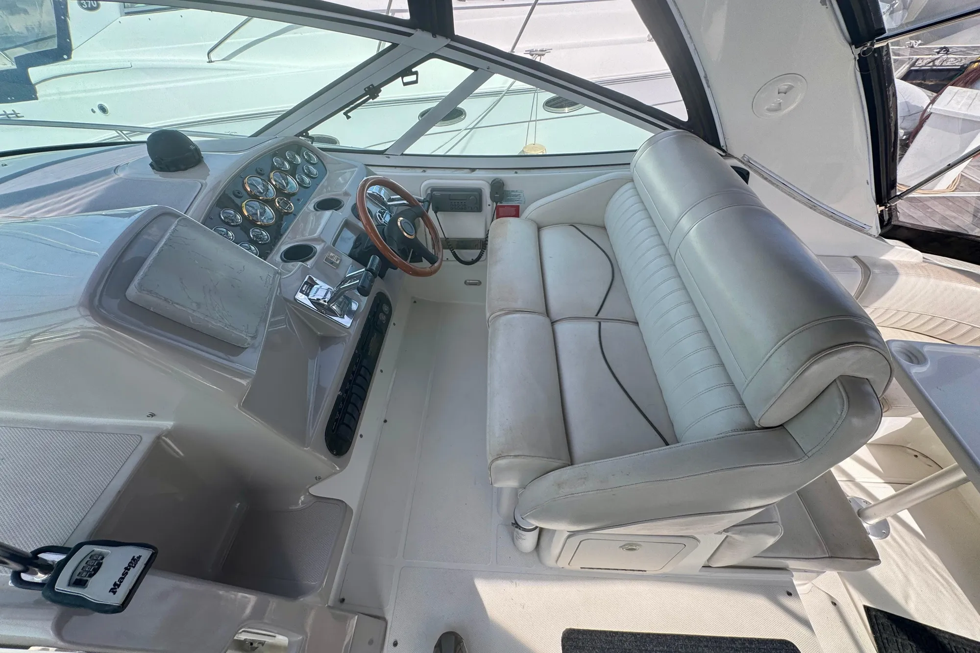 2001 Cruisers Yachts 3470 Express cockpit with leather seating and control panel.