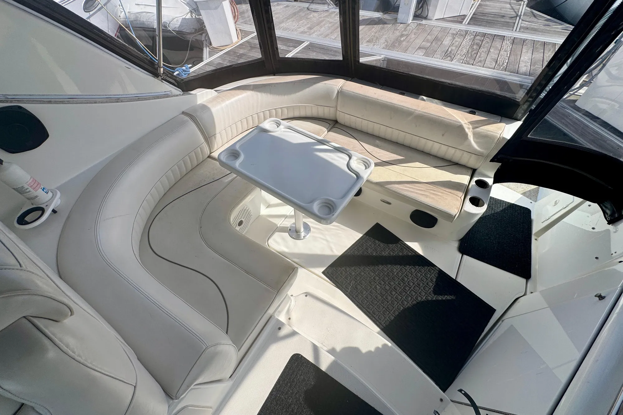 2001 Cruisers Yachts 3470 Express interior with curved seating and table.