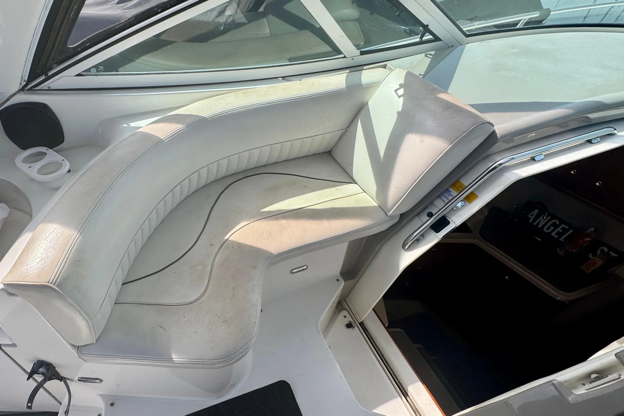 2001 Cruisers Yachts 3470 Express interior seating area with white upholstery.