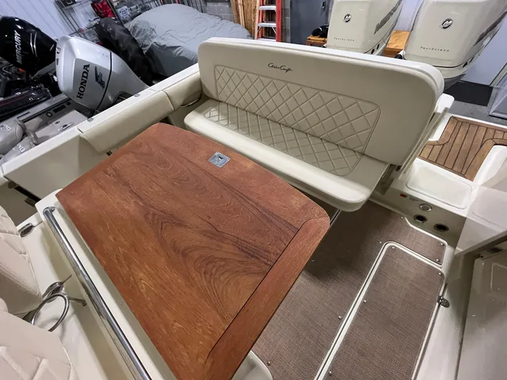  Yacht Photos Pics 2020 Chris-Craft 30 Catalina interior with wooden table and cushioned seating.