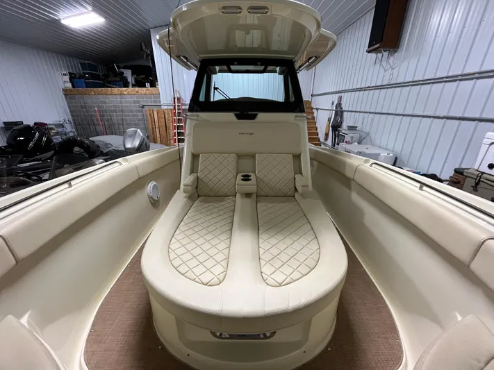  Yacht Photos Pics 2020 Chris-Craft 30 Catalina boat interior with beige seating in a storage facility.
