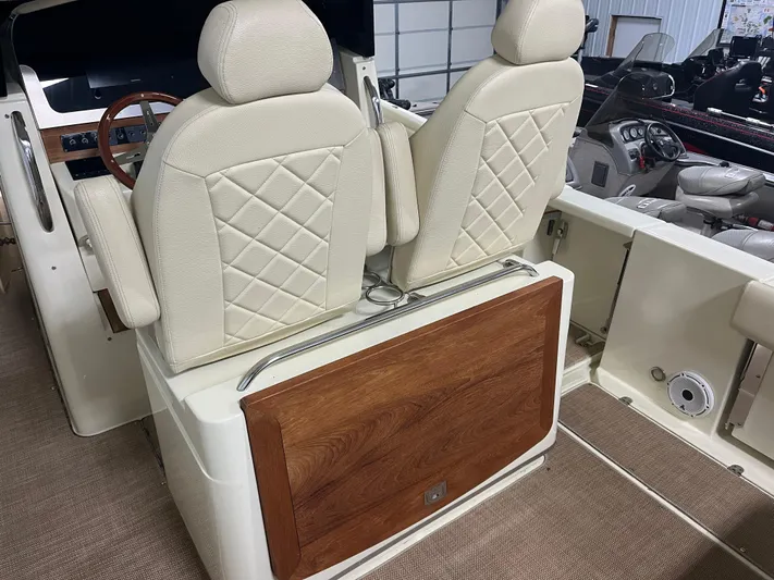  Yacht Photos Pics 2020 Chris-Craft 30 Catalina interior with beige leather seats and wooden accents.