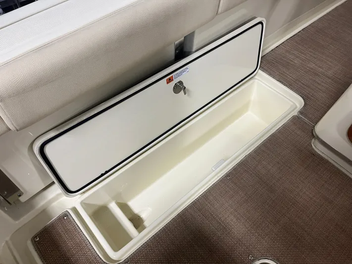  Yacht Photos Pics Storage compartment on 2020 Chris-Craft 30 Catalina boat, featuring a secure latch and spacious interior.
