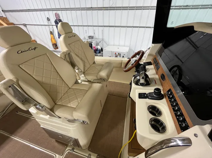  Yacht Photos Pics Luxurious 2020 Chris-Craft 30 Catalina helm with beige leather seats and modern controls.