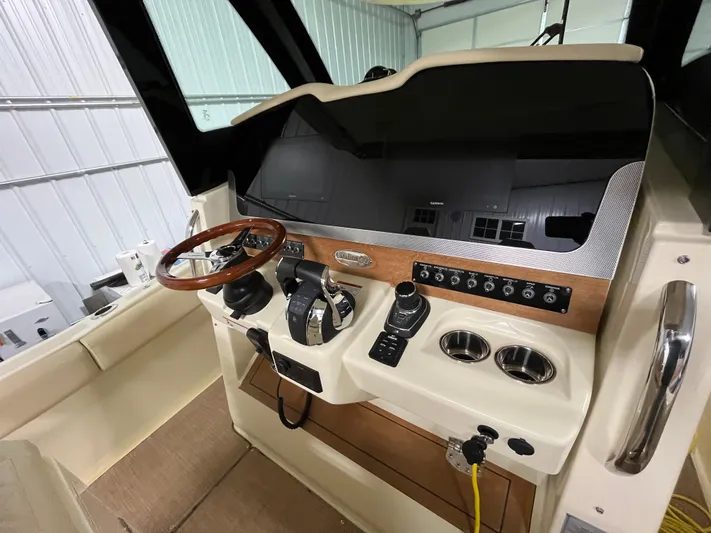  Yacht Photos Pics 2020 Chris-Craft 30 Catalina helm with wooden steering wheel and modern controls.