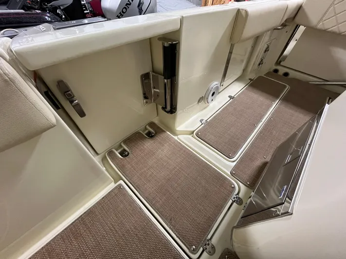  Yacht Photos Pics 2020 Chris-Craft 30 Catalina boat interior with beige flooring and storage compartments.