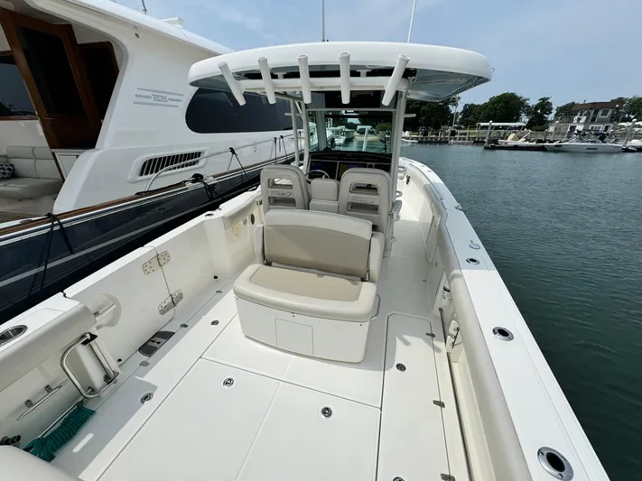 Just Wednesdays Yacht Photos Pics 2022 Boston Whaler 330 Outrage boat docked, featuring spacious seating and sleek design.