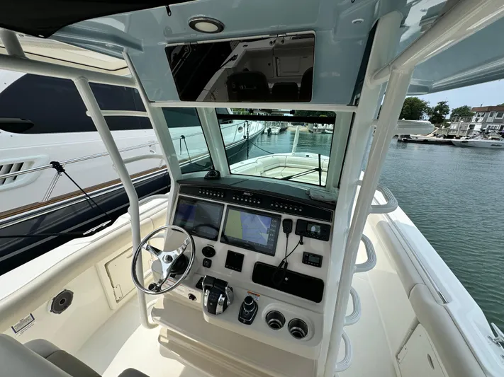 Just Wednesdays Yacht Photos Pics 2022 Boston Whaler 330 Outrage helm with advanced navigation systems, docked at marina.