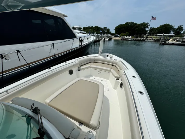 Just Wednesdays Yacht Photos Pics 2022 Boston Whaler 330 Outrage docked, showcasing spacious bow seating and sleek design.