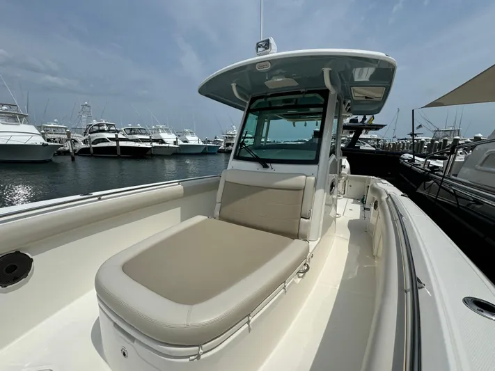 Just Wednesdays Yacht Photos Pics 2022 Boston Whaler 330 Outrage boat docked at marina, showcasing spacious seating and sleek design.