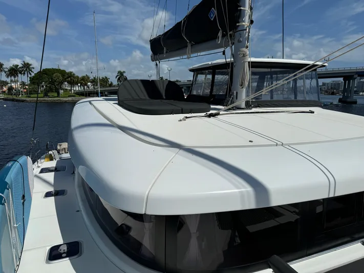  Yacht Photos Pics 2023 Lagoon 42 catamaran on water, featuring sleek design and spacious deck.