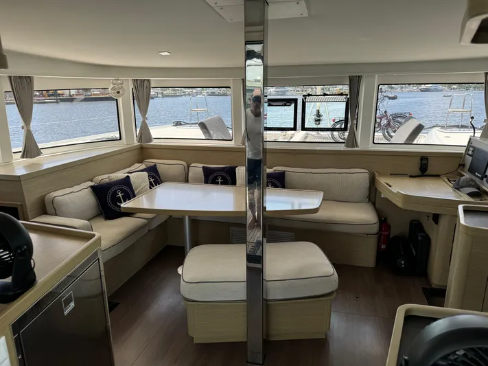  Yacht Photos Pics Interior of 2023 Lagoon 42 catamaran with spacious seating and panoramic windows.
