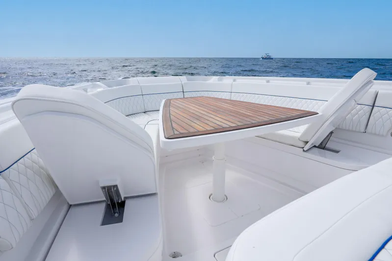  Yacht Photos Pics 2024 Intrepid 427 Nomad SE boat interior with elegant seating and wooden table.
