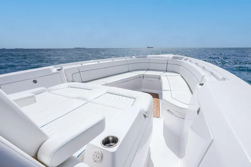  Yacht Photos Pics Luxurious 2024 Intrepid 427 Nomad SE boat interior with white seating, ocean view.