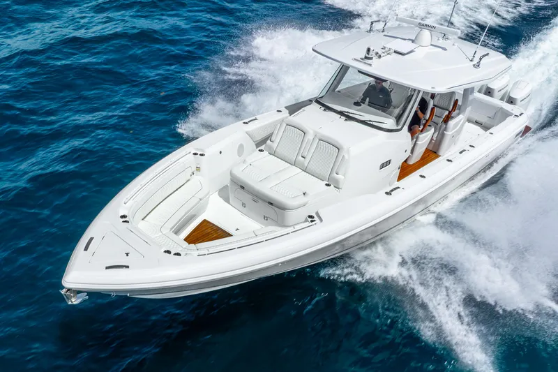  Yacht Photos Pics 2024 Intrepid 427 Nomad SE cruising on blue ocean waters.