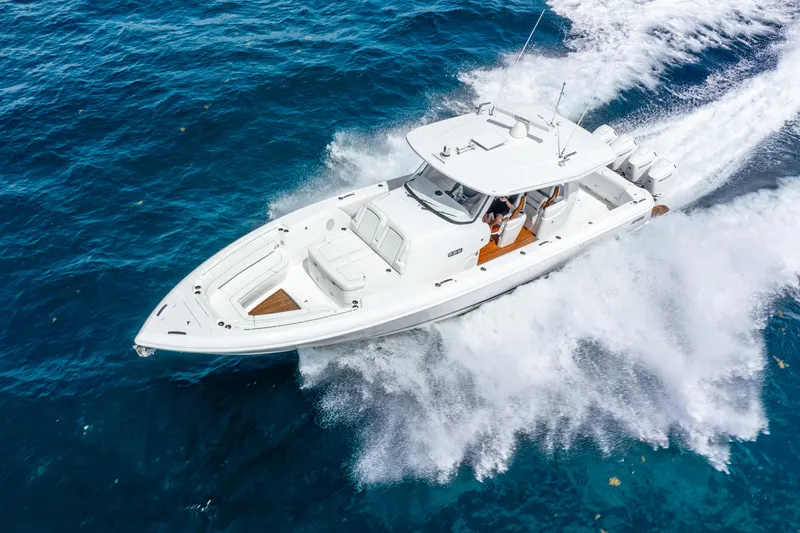  Yacht Photos Pics 2024 Intrepid 427 Nomad SE cruising on vibrant blue ocean waters.