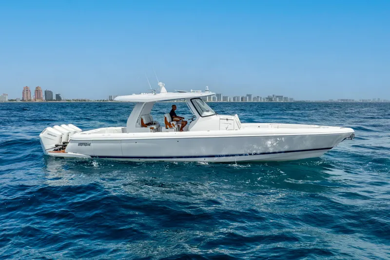  Yacht Photos Pics 2024 Intrepid 427 Nomad SE boat cruising on open water, clear blue sky background.