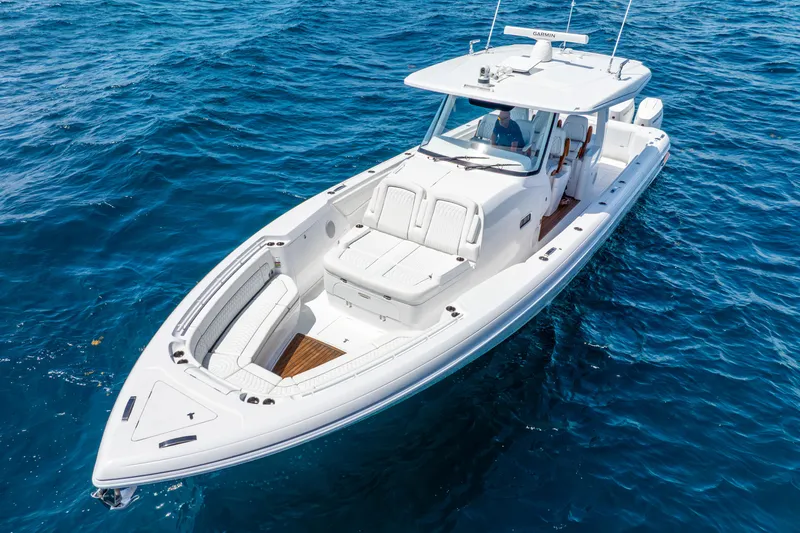  Yacht Photos Pics 2024 Intrepid 427 Nomad SE boat cruising on clear blue ocean waters.