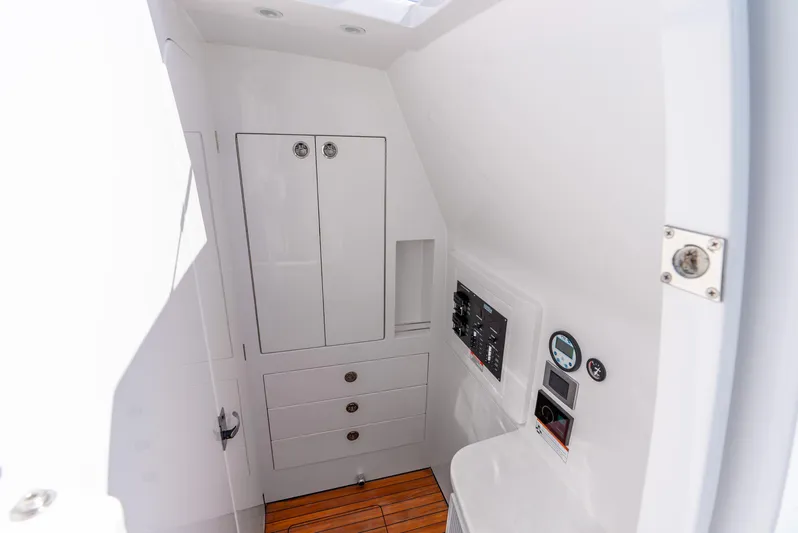  Yacht Photos Pics 2024 Intrepid 427 Nomad SE interior cabin with control panel and storage.