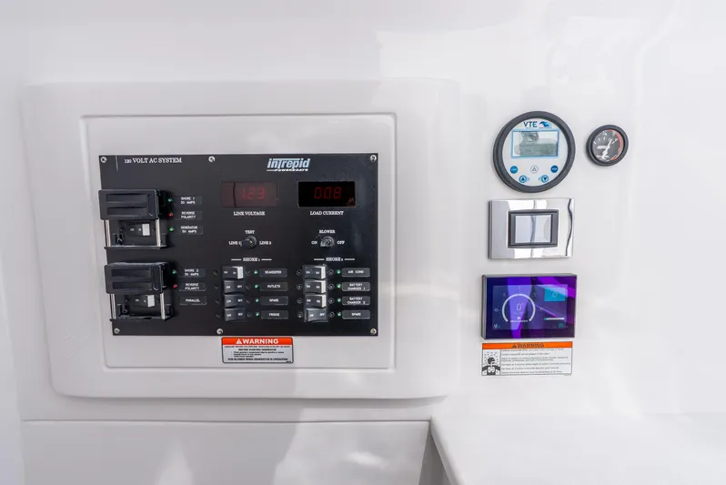  Yacht Photos Pics Control panel of 2024 Intrepid 427 Nomad SE boat, featuring voltage and current displays.