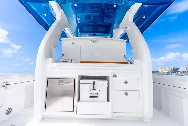  Yacht Photos Pics 2024 Intrepid 427 Nomad SE boat interior with sleek white cabinetry and blue accents.