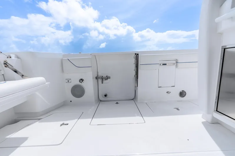  Yacht Photos Pics 2024 Intrepid 427 Nomad SE boat deck with sleek white design under blue sky.