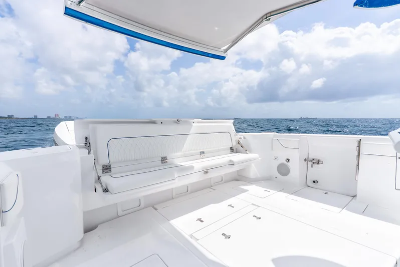  Yacht Photos Pics 2024 Intrepid 427 Nomad SE boat interior with white seating, ocean view, and blue sky.