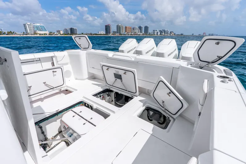  Yacht Photos Pics 2024 Intrepid 427 Nomad SE boat with open storage compartments and multiple outboard engines.