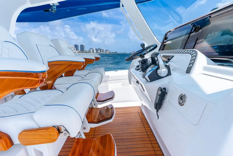  Yacht Photos Pics 2024 Intrepid 427 Nomad SE boat interior with luxurious seating and modern controls.