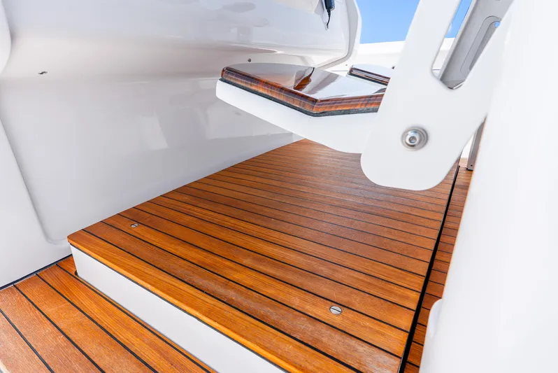  Yacht Photos Pics 2024 Intrepid 427 Nomad SE boat with sleek wooden deck and modern design.