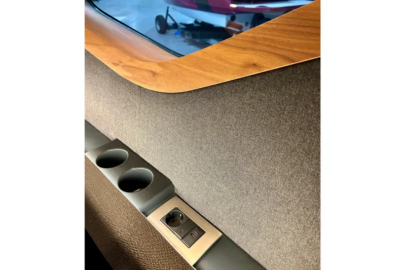  Yacht Photos Pics Interior detail of Flynt Yachts Centura 32, 2026 model, featuring cup holders and wood trim.