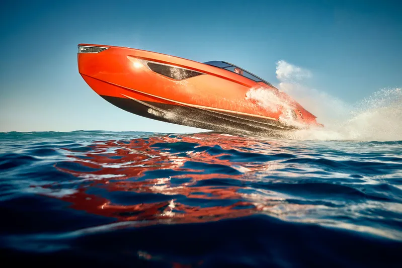  Yacht Photos Pics Flynt Yachts Centura 32, 2026 model, speeding on open water, vibrant orange hull.