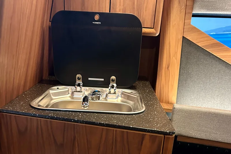  Yacht Photos Pics Luxurious kitchen sink in 2026 Flynt Yachts Centura 32, featuring modern design and wood finish.