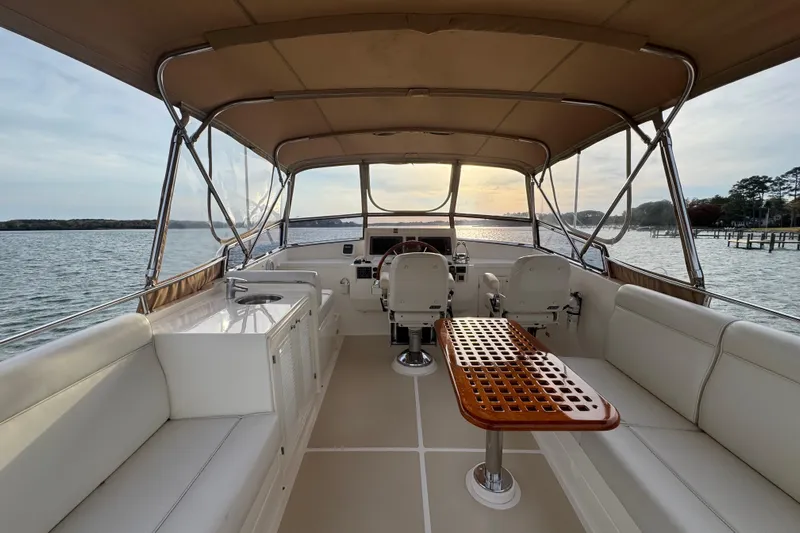 Adagio Yacht Photos Pics 2011 Grand Banks 47 Heritage EU yacht interior with seating and helm, overlooking serene waters.