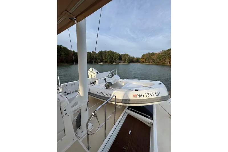Adagio Yacht Photos Pics 2011 Grand Banks 47 Heritage EU yacht with tender on deck, overlooking serene lake and forest.