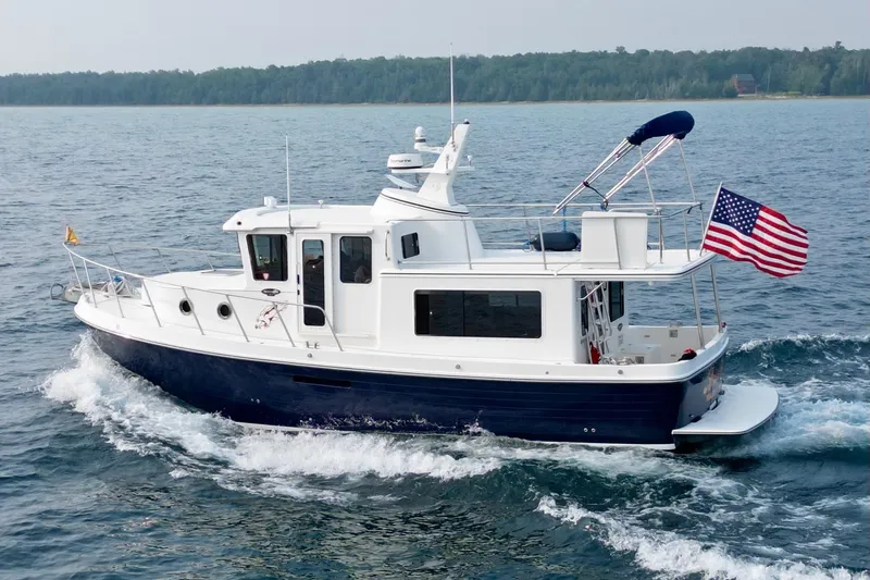  Yacht Photos Pics 2018 American Tug 365 cruising on open water with American flag.