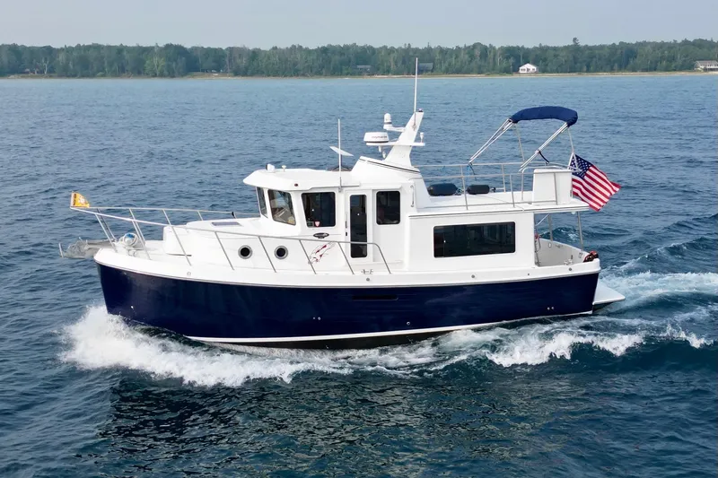  Yacht Photos Pics 2018 American Tug 365 cruising on open water with American flag.