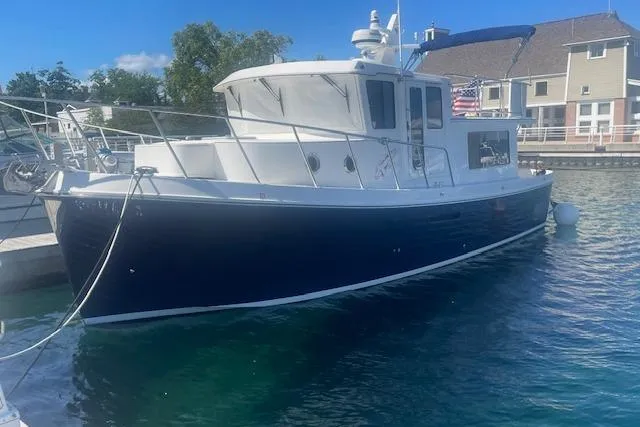  Yacht Photos Pics American Tug 365, 2018 model, docked in a marina with clear blue water.