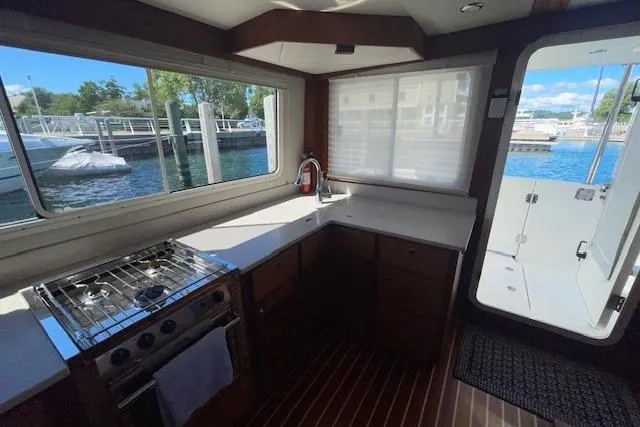  Yacht Photos Pics Interior of 2018 American Tug 365 with kitchen and marina view.