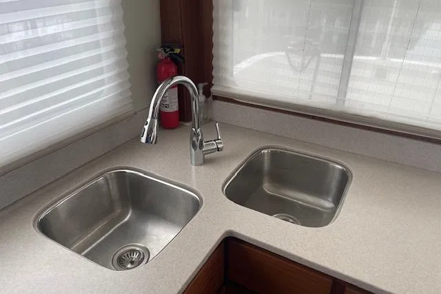  Yacht Photos Pics Modern kitchen sink area in 2018 American Tug 365 boat, featuring dual stainless steel sinks.